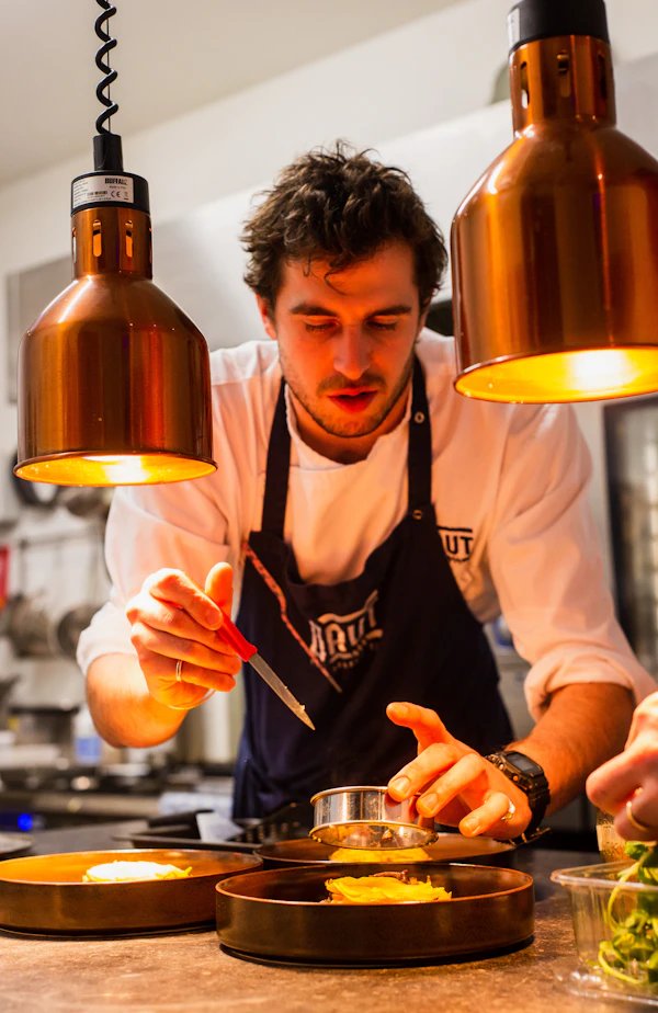 Chef cooking under strict hygiene protocols